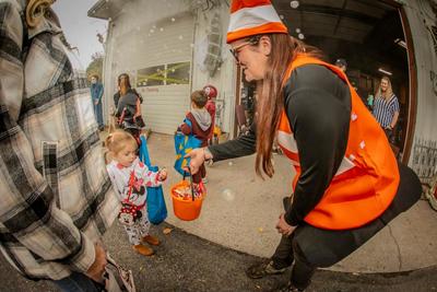 Business owners sharing candy with children